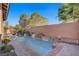 Lush backyard featuring a pool, spa, and lush greenery offering a private oasis at 11369 Rancho Villa Verde Pl, Las Vegas, NV 89138