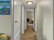 Hallway with neutral walls and trim leading to other areas of the home, and a vintage world globe at 1455 E Katie Ave # K14, Las Vegas, NV 89119