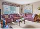 Inviting living room with plush sofas, patterned cushions, and large windows with floral decor at 1455 E Katie Ave # K14, Las Vegas, NV 89119