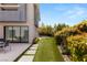 Beautifully landscaped backyard with a manicured lawn, and a stone-paved patio at 15 Gemstar Ln, Las Vegas, NV 89135