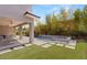 Picturesque backyard with a covered patio, lush artificial turf, and a sparkling pool at 15 Gemstar Ln, Las Vegas, NV 89135