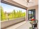 Outdoor balcony with a seating area and scenic views of lush bamboo plants and neighboring houses, providing a private retreat at 15 Gemstar Ln, Las Vegas, NV 89135