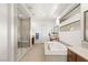 Bright bathroom featuring a soaking tub, walk-in shower with bench, and modern finishes at 15 Gemstar Ln, Las Vegas, NV 89135