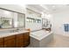 Spacious bathroom with a soaking tub, dual vanities, modern fixtures, and ample counter space at 15 Gemstar Ln, Las Vegas, NV 89135