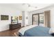 Bright bedroom with access to a private patio, sleek dresser, and hardwood floors at 15 Gemstar Ln, Las Vegas, NV 89135