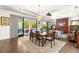 Bright dining room features a wood table with seating for six and sliding glass doors to the backyard at 15 Gemstar Ln, Las Vegas, NV 89135
