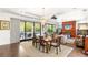 Bright dining room with seating for six, chandelier lighting and sliding glass door access to outdoor entertaining space at 15 Gemstar Ln, Las Vegas, NV 89135