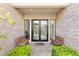 Elegant home entrance with stone accents, modern double doors, and decorative benches at 15 Gemstar Ln, Las Vegas, NV 89135