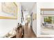 Bright hallway with hardwood floors, stylish console table and access to outdoor dining at 15 Gemstar Ln, Las Vegas, NV 89135