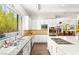 Bright kitchen features white cabinetry, stainless steel appliances, a large island and backyard view at 15 Gemstar Ln, Las Vegas, NV 89135