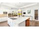 Bright kitchen featuring white cabinets, stainless steel appliances, and a large central island with cooktop and seating at 15 Gemstar Ln, Las Vegas, NV 89135