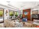 Relaxing living room with modern fireplace, access to backyard pool, and comfortable seating at 15 Gemstar Ln, Las Vegas, NV 89135