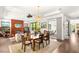 Open-concept living and dining area featuring a fireplace, chandelier, and sliding doors to outdoor patio at 15 Gemstar Ln, Las Vegas, NV 89135
