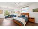 Spacious main bedroom featuring a ceiling fan, hardwood floors, and an inviting seating area with ample natural light at 15 Gemstar Ln, Las Vegas, NV 89135