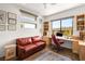 Bright office space with custom built-ins, large windows, and a comfortable seating area at 15 Gemstar Ln, Las Vegas, NV 89135