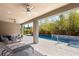 Inviting outdoor space with a covered patio, ceiling fans, and views of the refreshing pool at 15 Gemstar Ln, Las Vegas, NV 89135