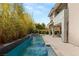 Serene backyard oasis with a sleek pool, verdant foliage, and ample patio space at 15 Gemstar Ln, Las Vegas, NV 89135