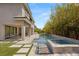 Backyard oasis featuring a luxurious pool, spa, and lush landscaping, perfect for outdoor living at 15 Gemstar Ln, Las Vegas, NV 89135