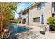 Stunning backyard featuring a modern pool, patio, and lush landscaping at 15 Gemstar Ln, Las Vegas, NV 89135