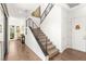 Contemporary staircase featuring hardwood floors, modern railings, and natural light, creating a bright and inviting entryway at 15 Gemstar Ln, Las Vegas, NV 89135