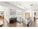 Modern staircase featuring wood floors and metal railings, offering views of the surrounding landscape through horizontal windows at 15 Gemstar Ln, Las Vegas, NV 89135