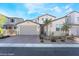 Charming two-story home featuring a brick driveway, a two-car garage, and desert landscaping at 19 Cresta Villa Ct, Henderson, NV 89011
