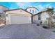 Two-story home with brick driveway, a two-car garage, and desert landscaping at 19 Cresta Villa Ct, Henderson, NV 89011