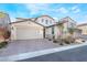 Two-story home featuring a brick driveway, a two-car garage, and desert landscaping at 19 Cresta Villa Ct, Henderson, NV 89011