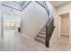 Bright, open foyer with tile flooring, stairs, and views into the adjacent rooms at 19 Cresta Villa Ct, Henderson, NV 89011