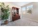 Cozy living room with a glass cabinet and natural light from windows at 19 Cresta Villa Ct, Henderson, NV 89011
