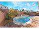 Backyard view displays a sparkling pool area, enclosed by a decorative brick wall and lush landscaping, ensuring privacy at 19 Cresta Villa Ct, Henderson, NV 89011