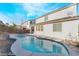 Lush backyard features a swimming pool with a lounging deck and the home's exterior in the background at 19 Cresta Villa Ct, Henderson, NV 89011