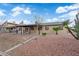 A spacious backyard with gravel landscaping, patio, mature trees, and privacy fence, perfect for outdoor living at 1913 Piccolo Way, Las Vegas, NV 89146