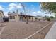 Spacious backyard featuring gravel landscaping, a covered patio, and mature trees for added privacy at 1913 Piccolo Way, Las Vegas, NV 89146