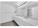 A bathroom features double sinks, a large mirror, modern fixtures and a shower/tub combination at 1913 Piccolo Way, Las Vegas, NV 89146