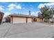 Single-story home featuring a two-car garage, mature shade tree, and arched entryway at 1913 Piccolo Way, Las Vegas, NV 89146