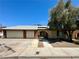 Charming single-story home featuring a three-car garage, neutral stucco, and mature landscaping at 1913 Piccolo Way, Las Vegas, NV 89146