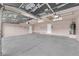 A spacious two-car garage features a concrete floor and white walls at 1913 Piccolo Way, Las Vegas, NV 89146