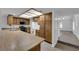 Bright kitchen with wood cabinets, long countertops, unique ceiling lighting, and stainless steel sink at 1913 Piccolo Way, Las Vegas, NV 89146