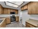 Kitchen featuring stainless steel stove, unique ceiling lighting, and wood cabinets at 1913 Piccolo Way, Las Vegas, NV 89146