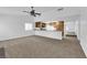 Open concept living room with a ceiling fan and a view into the kitchen at 1913 Piccolo Way, Las Vegas, NV 89146