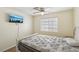 Inviting bedroom with a ceiling fan and a mounted TV for entertainment at 2128 Petersham Ct # C, Las Vegas, NV 89108