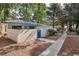 Charming single-story home with blue tile roof, gated courtyard, and mature trees in a well-maintained community at 2128 Petersham Ct # C, Las Vegas, NV 89108