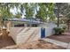 Charming single-story home with blue tile roof, gated courtyard, and mature trees in a well-maintained community at 2128 Petersham Ct # C, Las Vegas, NV 89108