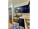 Modern kitchen features stainless steel appliances, navy cabinets and granite countertops at 2128 Petersham Ct # C, Las Vegas, NV 89108