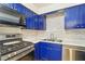 Charming kitchen featuring stainless steel appliances and custom blue cabinetry at 2128 Petersham Ct # C, Las Vegas, NV 89108