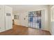 Open-concept living room with sliding doors, wood-look flooring, and ample natural light, creating a welcoming space at 2128 Petersham Ct # C, Las Vegas, NV 89108