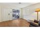 Bright living room featuring wood-look flooring, a sliding glass door to patio, and a comfortable reading area at 2128 Petersham Ct # C, Las Vegas, NV 89108