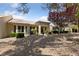 Back of house and backyard featuring mature trees and desert landscaping at 2208 Spring Water Dr, Las Vegas, NV 89134