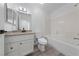 Bright bathroom featuring a single sink vanity with granite countertop and a shower-tub combo at 2208 Spring Water Dr, Las Vegas, NV 89134